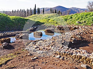 An archaeological site featuring the ruins of an ancient villa in Tuscany, Italy