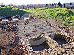 An archaeological site featuring the ruins of an ancient villa in Tuscany, Italy