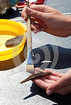 Archaeologist clears brush iron tip medieval arrowhead
