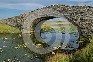 The arched Aberffraw Bridge in Anglesey