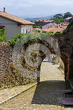 Arched access door to the star streets of the old town. San Vicente de la Barquera