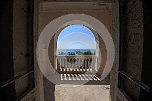 Arched balcony with balusters and sea view