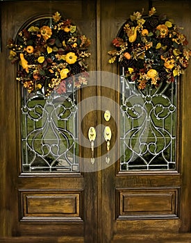 Arched Beveled front doors with Fall Wreths photo