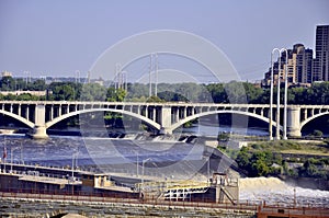 An arched bridge crosses the Mississippi River in Minneapolis, Minnesota.