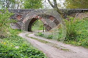 Arched bridge over a country road, arched passage under the railway