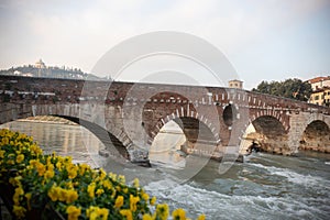 An arched bridge over flowing water - italian medieval landscape