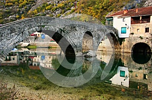 Arched bridge reflected in Crnojevica river, Montenegro