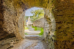 Arched door with a thick stone wall leading to the outer courtyard of the ruined castle of Esch-sur-Sure