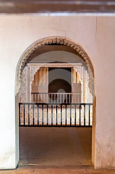 Arched entrance revealing detailed lattice screens within Alhambra historical Nasrid Palaces