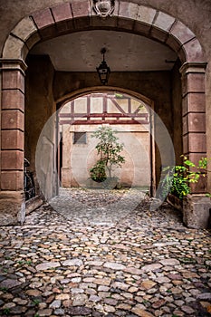 Arched entrance to courtyard on old European building