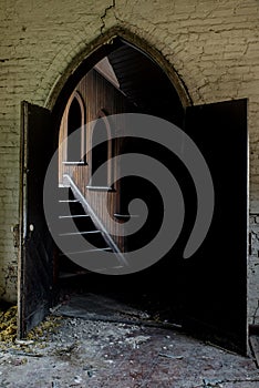 Arched Entry to Wood Paneled Hallway - Collapsing, Abandoned Church