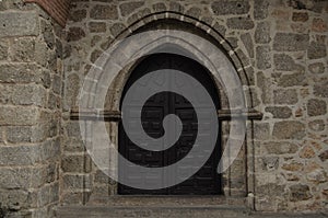 Arched Gate with Wooden Doors Wall of Stone Medieval Church