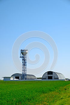 Arched hangars and tower. Large storage for agricultural crops. Agribusiness concept