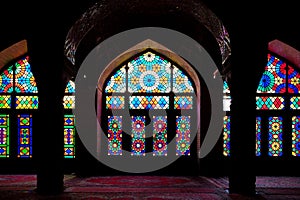 Arched interior with colourful tiles at Nasir al-Mulk pink mosque in Shiraz, Iran. Empty mosque with no people in the morning,
