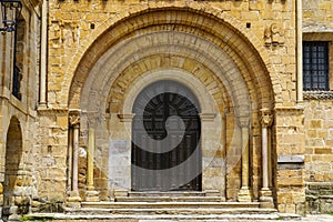 Arched main door, entrance to an old Romanesque church in northern Spain. Santillana del Mar