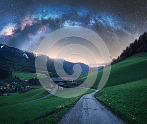 Arched Milky Way over the rural mountain road in summer in Italy