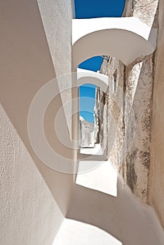 Arched narrow street in Emporio, Santorini, Greece photo