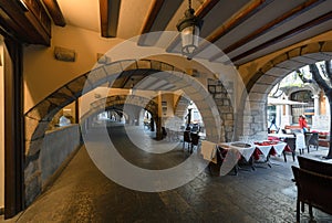Arched passage with cafes, Girona, Catalonia, Spain photo