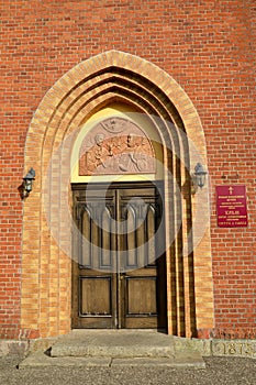 Arched portal of the main entrance. Krasnoznamensk,Kaliningrad region. Russian text - temple of the holy first-hand apostles Peter