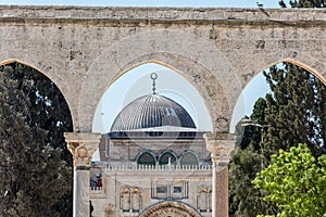 Arched South gateway with Siliver dome of Al-Aqsa Mosque at the square of Golden Dome of the Rock, in an Islamic shrine located on