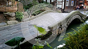 An arched stone bridge over the river,a bluestone bridge