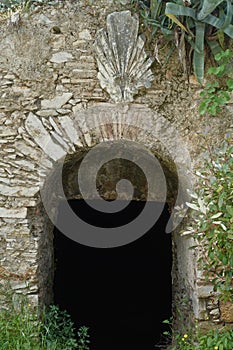 Arched stone gate of dark abandoned cellar