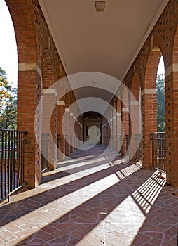 Arched walkway and morning sun vertical