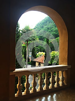 Arched Window frames made of concrete, Window open-air frame curve with a balcony railing to watch the view