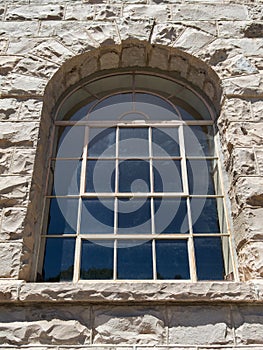 Arched window and rusticated stone masonry