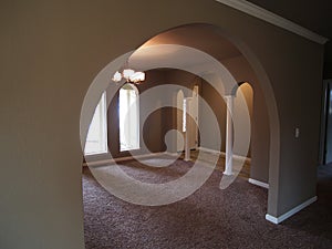 Arched Windows and front hall way of empty house