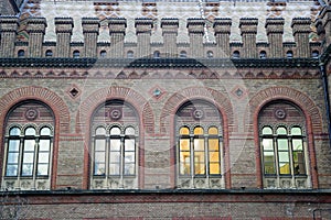 Arched windows, red brick building details