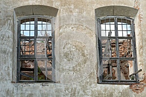 Arched Windows with wooden baseline in the wall of an old dilapidated house or Church. Historical value
