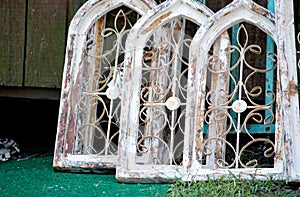 Arched wooden windows at a salvage yard