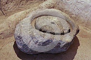 Archeological detail old grain grindstone