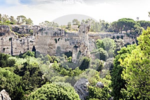 Archeological park, rocks near Greek Theatre of Syracuse, ruins of ancient monument, Sicily, Italy