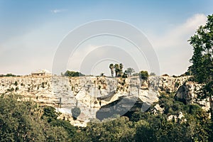 Archeological park, rocks near Greek Theatre of Syracuse, ruins of ancient monument, Sicily, Italy