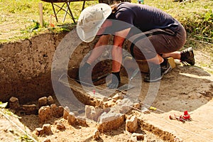 Archeological tools, Archeologist working on site, hand and tool.