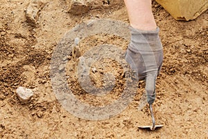 Archeological tools, Archeologist working on site, hand and tool.