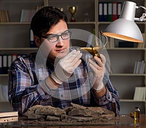 Archeologist working late night in office