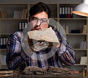 Archeologist working late night in office