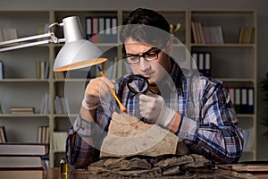 The archeologist working late night in office