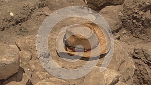 An Archeologists hat rests on an excavation dig site