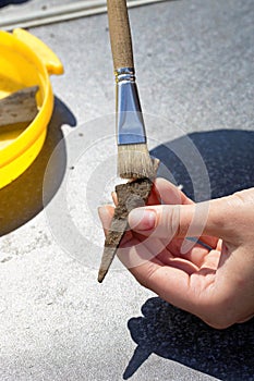 Archeology: cleaning the rusty tip of an ancient arrow from the soil