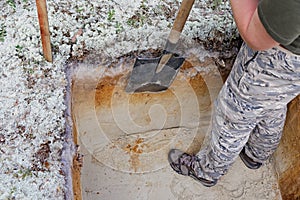 Archeology: rough cleaning of the excavation wall photo