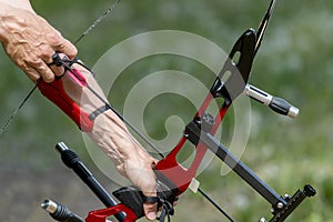 Archer pulls on the sport bow string, taking aim at his target at the competition