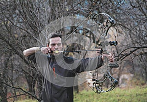 Archer shooting compound bow photo