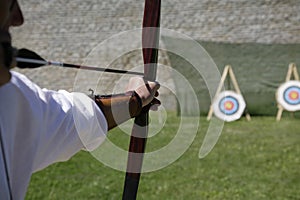 Archer shooting a long bow