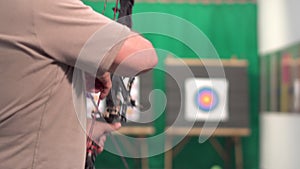 Archer Training With The Bow. Shooting the target in the background.