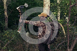 Archery hunter with his bow drawn back ready for a shot