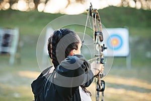 Archery, shooting range and target for sports training with a woman outdoor for bow practice. Archer athlete person with